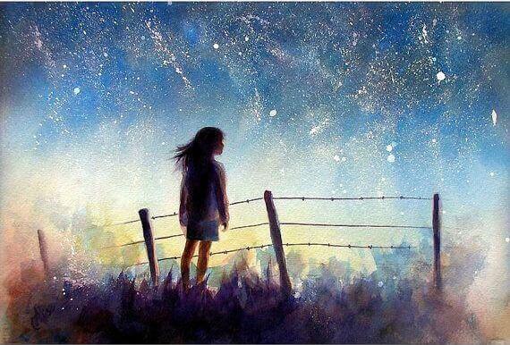 Jovem envolta em um céu estrelado