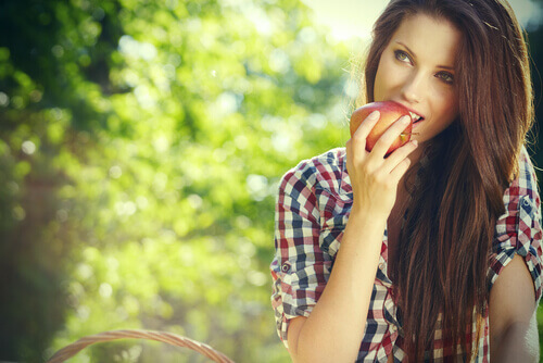 Mulher comendo uma maçã O fruto proibido