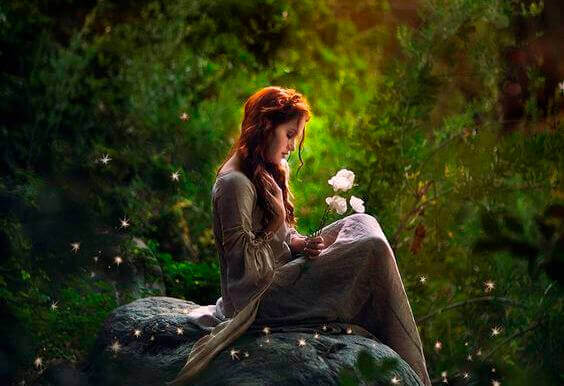 menina-em-bosque-segurando-flor