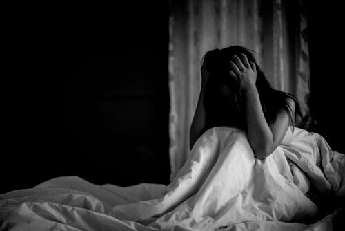 mulher-no-escuro-maos-na-cabeça Mulher sofrendo ataques de pânico noturnos