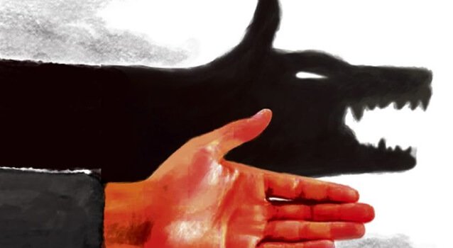 Mão fazendo sombra em forma de lobo