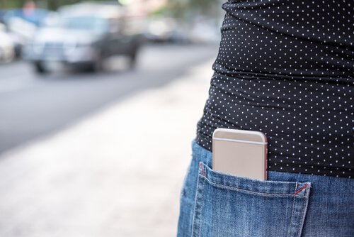 Mulher com celular guardado no bolso
