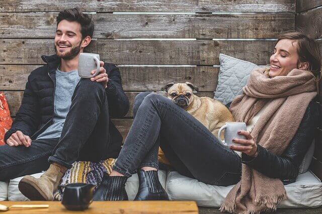 Casal se divertindo com cachorro