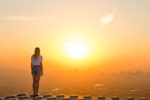 Mulher observando pôr do sol