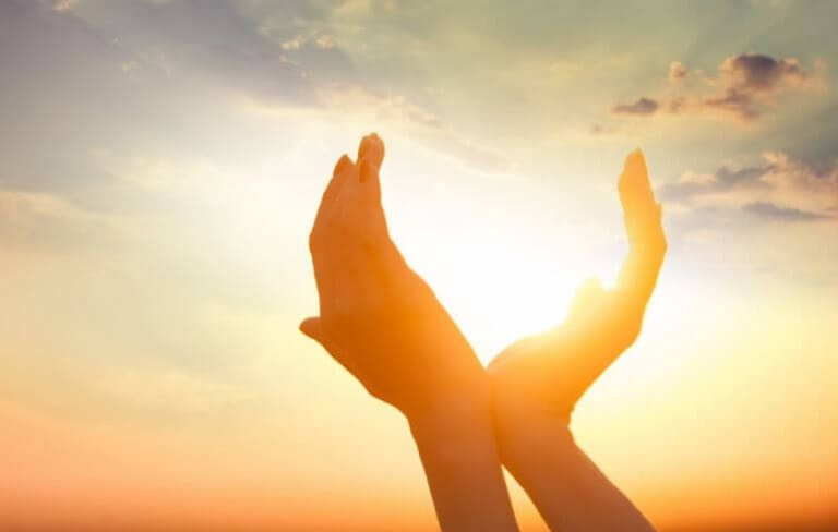 Mãos unidas diante do sol