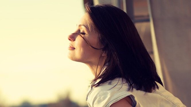 Mulher feliz de olhos fechados